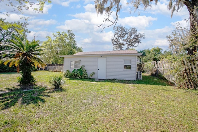 view of outbuilding with an outbuilding, central air condition unit, and a fenced backyard