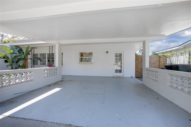 view of patio with a carport and fence