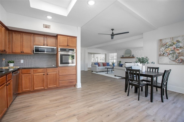 kitchen featuring visible vents, brown cabinets, a ceiling fan, tasteful backsplash, and stainless steel appliances