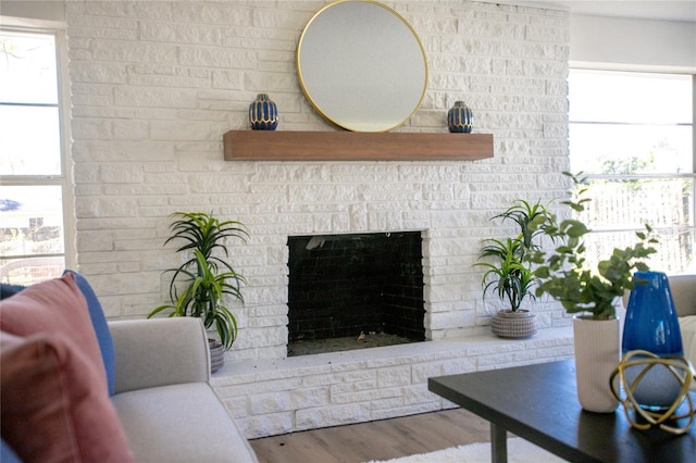 living room with wood finished floors and a fireplace