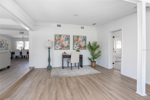 interior space with visible vents, light wood-style flooring, and crown molding