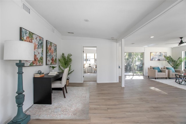 office with a ceiling fan, wood finished floors, visible vents, baseboards, and crown molding