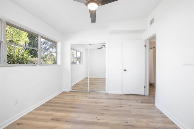 unfurnished bedroom with visible vents, baseboards, a closet, and light wood-style flooring