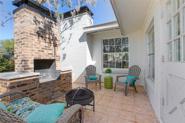 view of patio with an outdoor brick fireplace