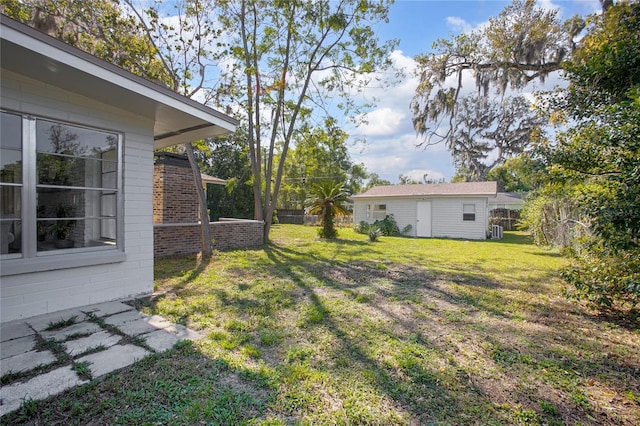 view of yard featuring central AC unit, an outdoor structure, and fence