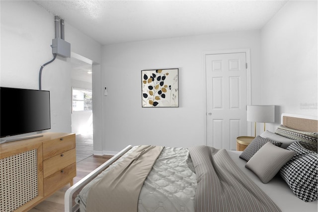 bedroom with light wood-style floors and baseboards