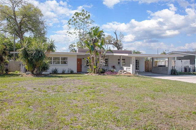 ranch-style house with an attached carport, fence, a front lawn, and driveway