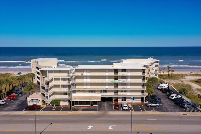 birds eye view of property with a water view and a view of the beach