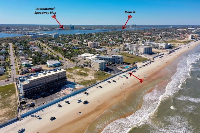 birds eye view of property featuring a water view, a view of city, and a view of the beach