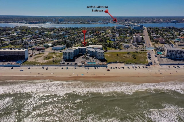 birds eye view of property with a water view and a view of the beach