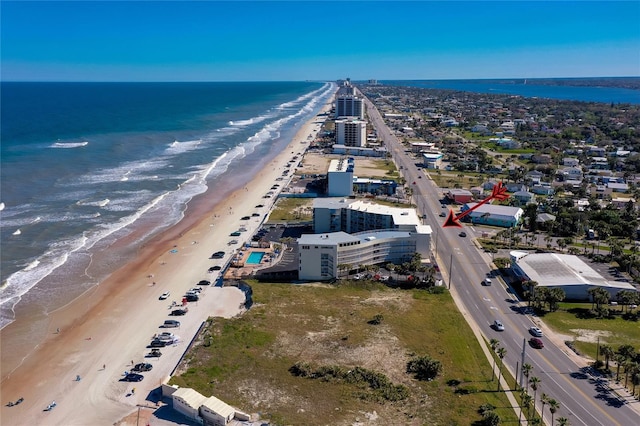 aerial view with a water view and a beach view