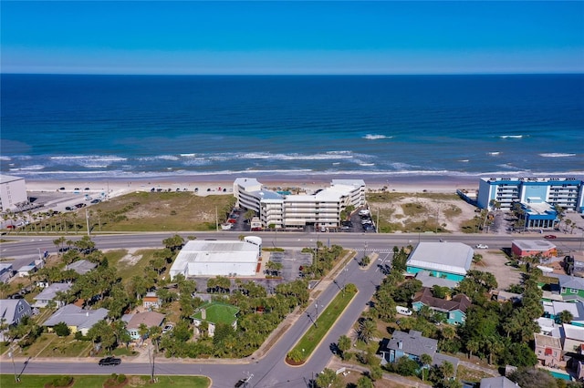 drone / aerial view with a beach view and a water view