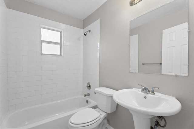 full bath featuring toilet,  shower combination, and a sink