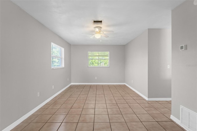 unfurnished room featuring visible vents, baseboards, and ceiling fan