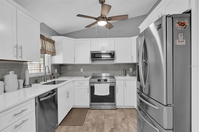 kitchen featuring a sink, appliances with stainless steel finishes, ceiling fan, and white cabinets