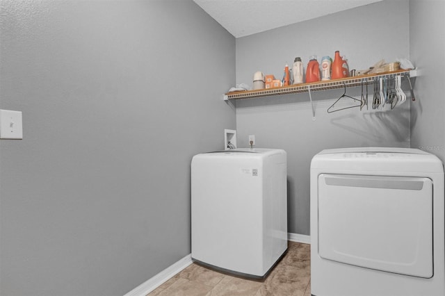 laundry area featuring laundry area, separate washer and dryer, and baseboards