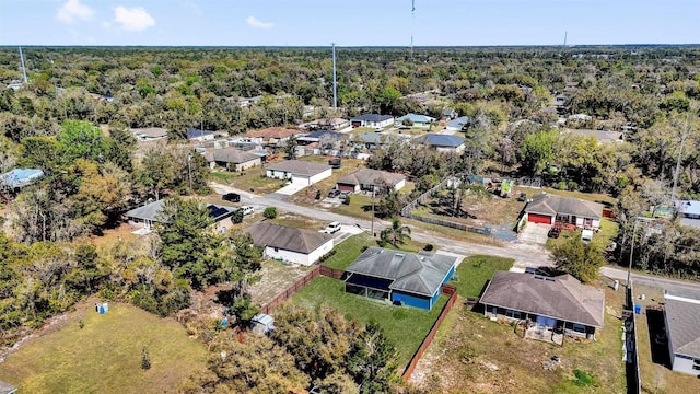 aerial view featuring a residential view and a wooded view