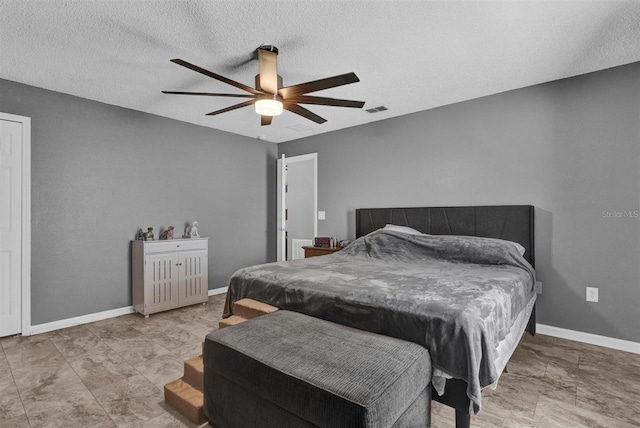 bedroom with visible vents, a textured ceiling, a ceiling fan, and baseboards