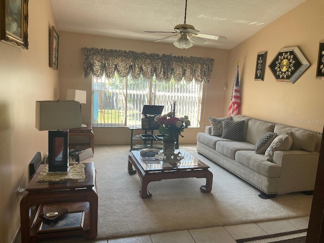 living room featuring carpet flooring, a textured ceiling, and a ceiling fan