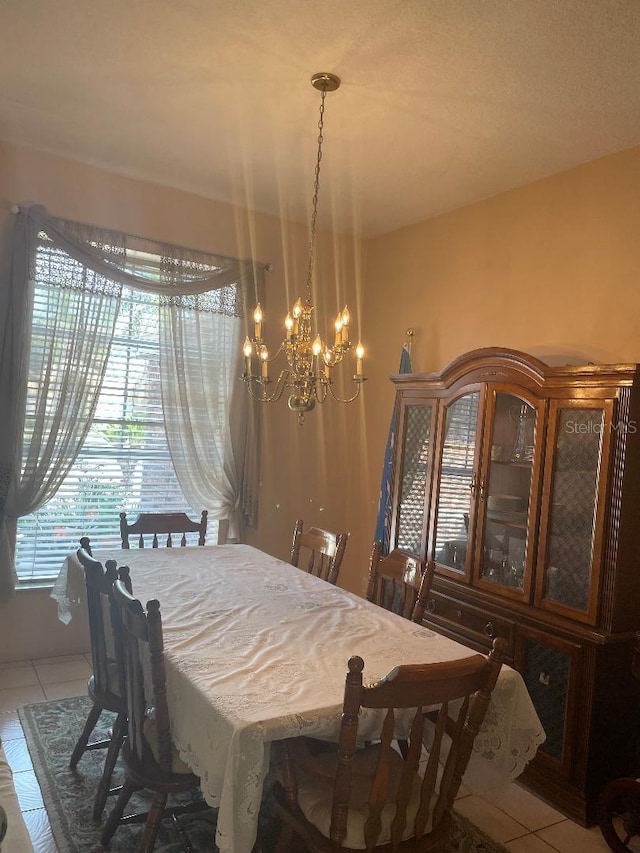 tiled dining space with a notable chandelier