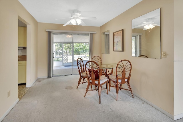 dining space with baseboards, carpet floors, and ceiling fan