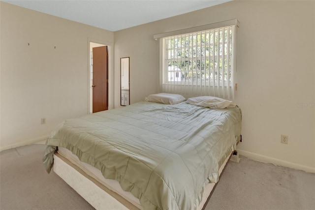 carpeted bedroom featuring baseboards