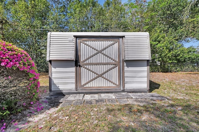 view of shed featuring fence