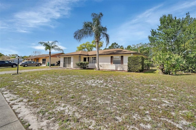 ranch-style home with a front lawn and stucco siding