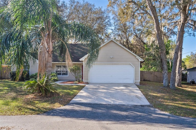 view of front of property with concrete driveway and fence