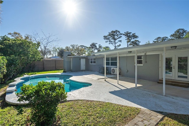 view of swimming pool with a patio, a fenced in pool, french doors, and fence