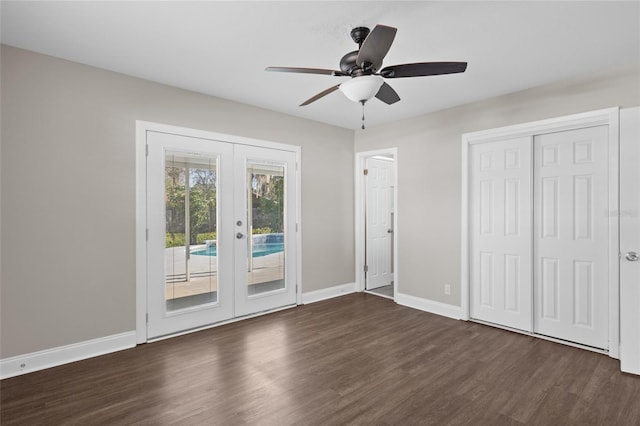 unfurnished bedroom featuring a ceiling fan, access to outside, french doors, baseboards, and dark wood-style flooring