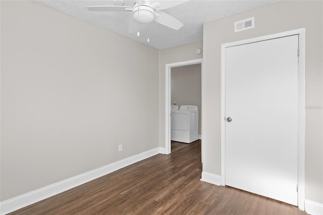 spare room featuring visible vents, a textured ceiling, wood finished floors, separate washer and dryer, and ceiling fan