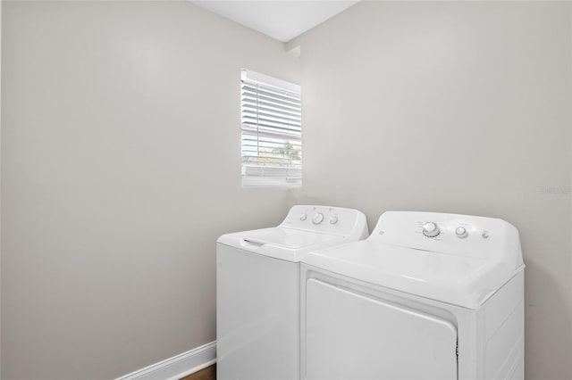 laundry room featuring laundry area, washing machine and dryer, and baseboards