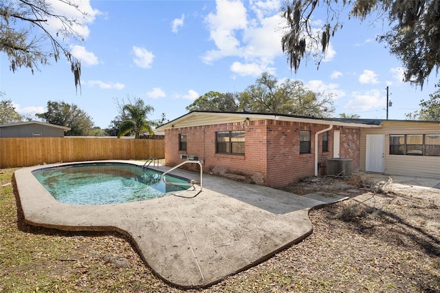 view of pool with cooling unit, a fenced in pool, a fenced backyard, and a patio area