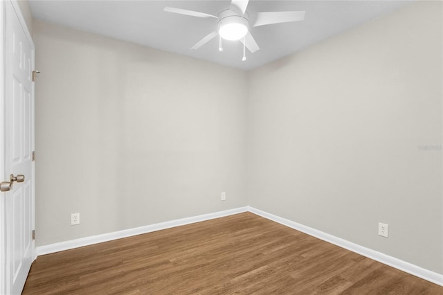 spare room featuring ceiling fan, baseboards, and wood finished floors