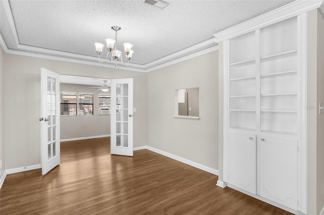 unfurnished dining area featuring visible vents, french doors, a textured ceiling, and ornamental molding