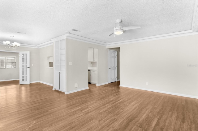 unfurnished living room with visible vents, a textured ceiling, crown molding, ceiling fan with notable chandelier, and light wood-type flooring