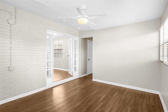 unfurnished room featuring a healthy amount of sunlight, baseboards, and wood finished floors