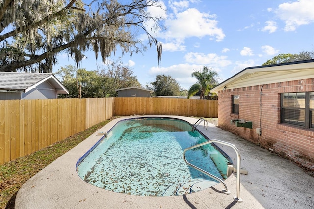 view of swimming pool with a patio, a fenced backyard, and a fenced in pool