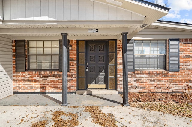 entrance to property with brick siding