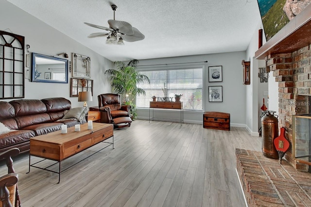 living room featuring wood finished floors, a ceiling fan, baseboards, vaulted ceiling, and a textured ceiling