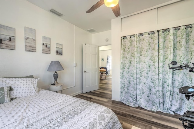 bedroom featuring visible vents, wood finished floors, and ceiling fan