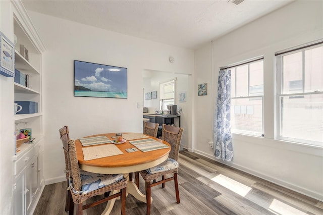 dining room with baseboards and wood finished floors