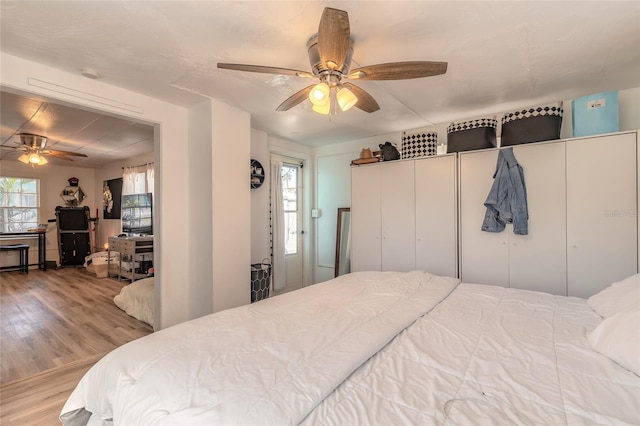 bedroom with wood finished floors and ceiling fan