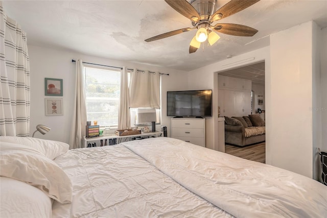 bedroom featuring a ceiling fan and wood finished floors