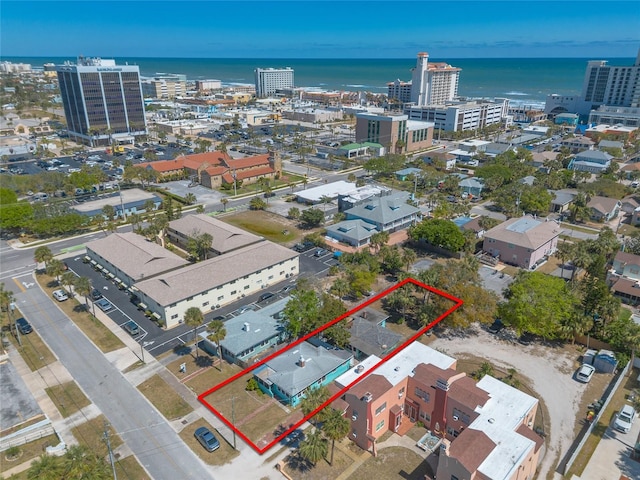 birds eye view of property featuring a water view and a view of city