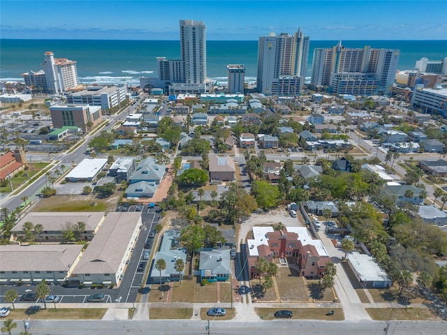 birds eye view of property with a water view and a city view