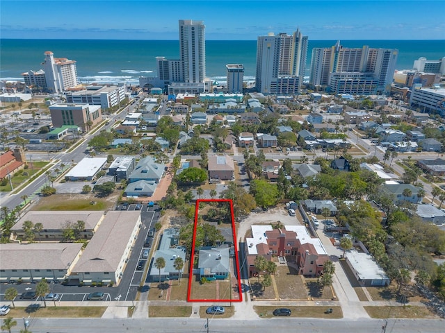 birds eye view of property featuring a water view and a city view