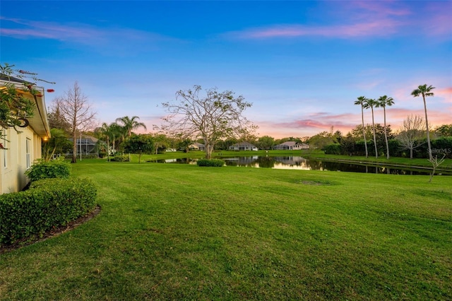 yard at dusk with a water view