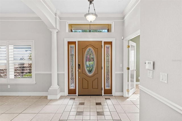 foyer with ornate columns, baseboards, ornamental molding, and light tile patterned flooring